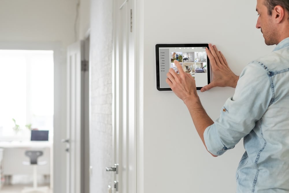 Man,Using,Tablet,Panel,Application,For,Control,Smart,Home,Living.