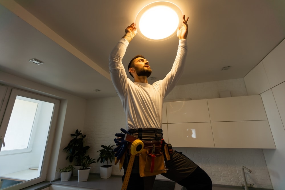 Electrician installing ceiling LED light