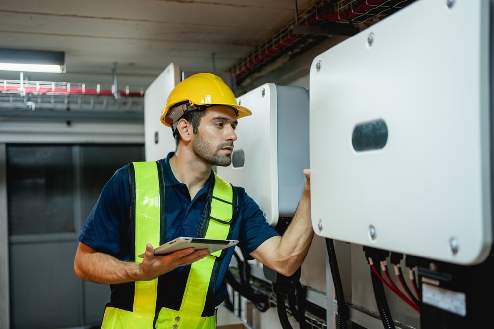 Electrician wiring electrical distribution board