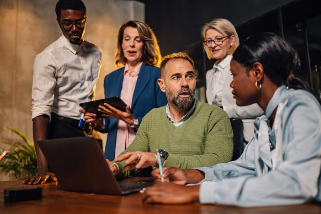 Interracial team of businesspeople working together on a laptop
